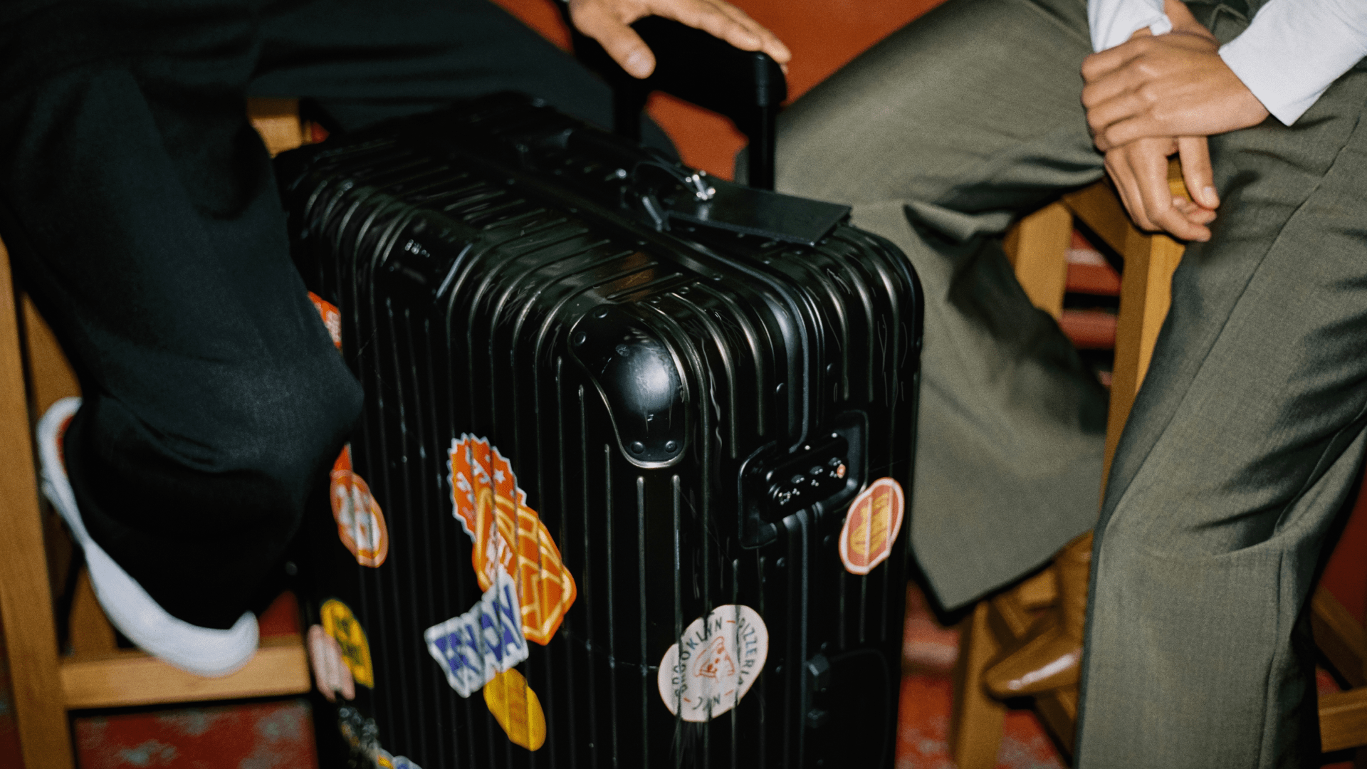 Couple sat with Rimowa case between them